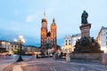 Cracow, Poland old town with St. Mary\'s Basilica and Adam Mickiewicz monument at the evening