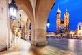 Cracow, Poland old town and St. Mary\'s Basilica seen from Cloth hall arch at night