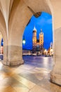 Cracow, Poland old town and St. Mary's Basilica seen from Cloth hall arch at night Royalty Free Stock Photo