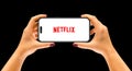 Cracow, Poland - 26 September 2022 : iPhone 14 Pro in a woman`s hands, application Netflix.