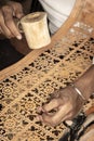Craft artist making traditional buffalo leather carving art in indonesia