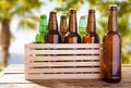 Craft beer bottles on wooden table on blurred tropical background