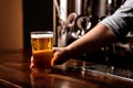 Craft beer for regular client. Bartender gives glass of light lager in interior of pub Royalty Free Stock Photo