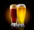Craft beer. Two glasses of cold light and dark beer isolated on black Royalty Free Stock Photo