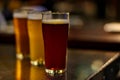 Craft beer on wooden table with blurred background in night club Royalty Free Stock Photo