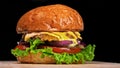 Craft burger is cooking on black background. Consist: sauce, lettuce, tomato, red onion, pickle, cheese, bacon, air bun Royalty Free Stock Photo