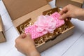 craft business - woman packing handmade baby floral headband in box for shipping Royalty Free Stock Photo