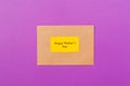 Craft envelope with greeting caed and text Happy Woman`s Day on purple background. Free space. Copy space for text