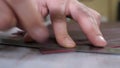 Craft factory authentic. Close-up shot of craft master cutting leather with utility knife. Handmade and leatherwork