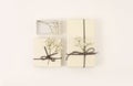 Craft gift boxes with flower on light beige background. Copy space for text message. Minimalism style template background. Flat Royalty Free Stock Photo