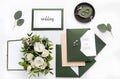 Craft green wedding envelopes with invitations on white