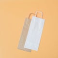 Craft long packaging bags on an orange background. Place for text and logo. The concept of packaging, gift, drink Royalty Free Stock Photo