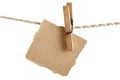 Craft note paper fastened with a vintage clothespin on a rope on a white background Royalty Free Stock Photo