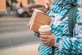 Craft packaging of delivered food in hands. Stack of food delivery boxes. Anonymous hands holding stack of delivery