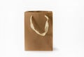 Craft paper bag with fabric handle on a white background. Isolated Royalty Free Stock Photo