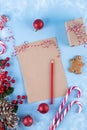 Craft paper card and decoration on blue table top view. Christmas mockup for greeting, plans, wishes, goals. Flat lay. Royalty Free Stock Photo