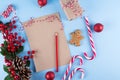 Craft paper card and decoration on blue table top view. Christmas mockup for greeting, plans, wishes, goals. Flat lay. Royalty Free Stock Photo