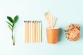 Craft paper coffee cup, pencil, green leaves sprout and recycled cutlery top view. Flat lay Zero waste, eco friendly Royalty Free Stock Photo