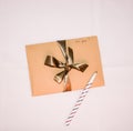 Craft paper envelope with golden ribbon, handwritten sign `for you`, and a pen Royalty Free Stock Photo