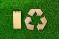 Craft paper on grass, recycling concept, top view