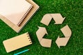 Craft paper on grass, recycling concept, top view