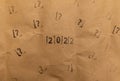 craft paper with 2022 and many stamped questions marks