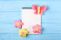 Craft pink and yellow butterfly and flowers with white paper, copyspace on blue wooden background. Hand made felt toys. Abstract s Royalty Free Stock Photo