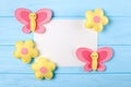 Craft pink and yellow butterfly and flowers with white paper, copyspace on blue wooden background. Hand made felt toys. Abstract s Royalty Free Stock Photo