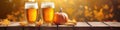 Craft pumpkin ale. Autumn beer in a glass on a wooden table and orange pumpkins Royalty Free Stock Photo