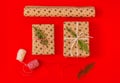 Craft set for gift wrapping and two present boxes on red background Royalty Free Stock Photo