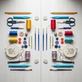 Craft tools are arranged symmetrically on a wooden surface. Items include knitting Royalty Free Stock Photo