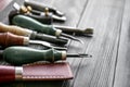 Craft tools for work with leather on wooden table Royalty Free Stock Photo