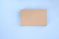 Craft unlabeled cardboard package box presented on stressed brushed on a blue background. The concept of delivery, mail Royalty Free Stock Photo