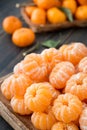 A craft wooden platter of peeled Clementine tangerines