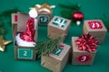 Crafted Advent calendar: paper cubes featuring numbers set against a lively green background. Embrace the Christmas