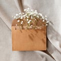 Crafted envelope with flowers on beige background, aesthetic boho congratulation or greeting letter concept, gift template with