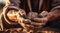 Soiled hand shaping clay in an outdoor workshop