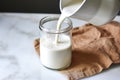 crafting homemade oat milk captured mid-squeeze through a fine-mesh bag