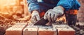 Crafting a sturdy foundation with red bricks under the midday sun at a construction site Royalty Free Stock Photo