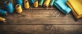 Crafting tools arranged on a wooden table with vibrant threads and fabrics in a creative workspace Royalty Free Stock Photo