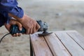 Craftman polishing pinewood with sander machine