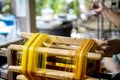 Crafts and craftsmanship. Silk raising for silk threads. yarn warping machine in a textile weaving crafsmanship. Hand of woman