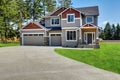 Craftsman American house with rocks trim, garage and concrete floor porch