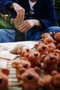 Craftsman artist hands making cute animal pottery or handcraft clay dolls demonstrating in local craftsmanship market