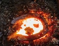 Warming iron in fire to create  horseshoe on abvil Royalty Free Stock Photo