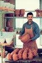 Craftsman with ceramic crockery Royalty Free Stock Photo