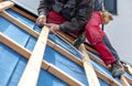 Craftsman or construction worker install a new roof, roofing tools, new metallic roof or metal sheet, building concept Royalty Free Stock Photo