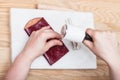 Craftsman corrects embossing of leather pouch Royalty Free Stock Photo