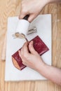 Craftsman corrects stamping of leather pouch Royalty Free Stock Photo