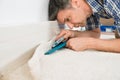 Craftsman cutting carpet Royalty Free Stock Photo